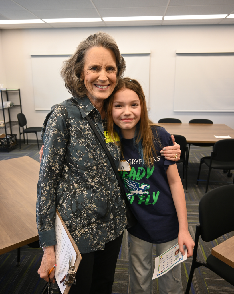 student smiles with community member