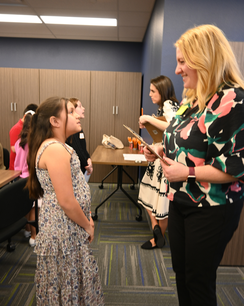 student smiles with community member