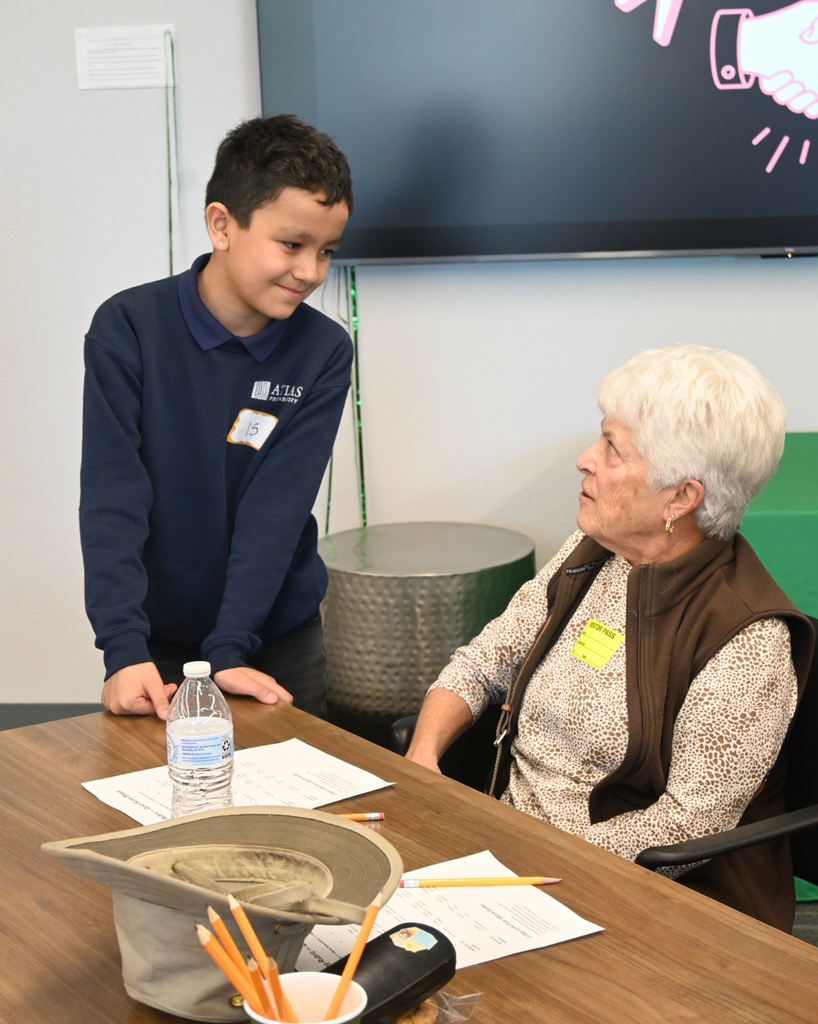 student smiles with community member