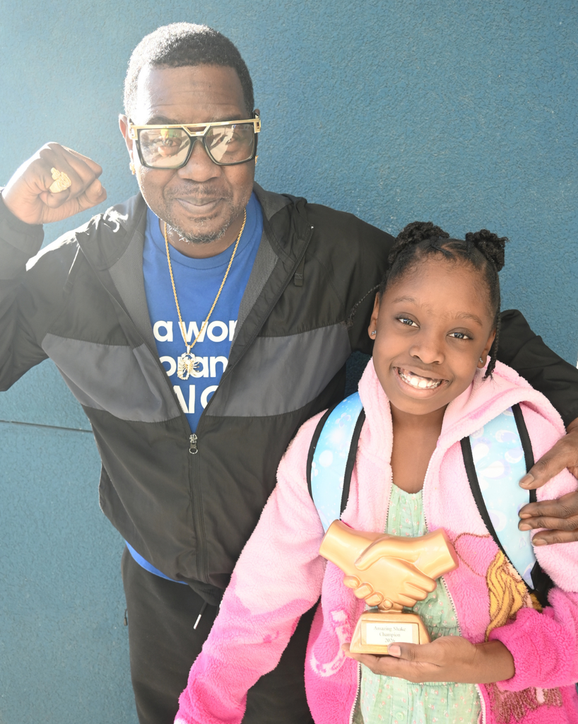 student smiles with community member