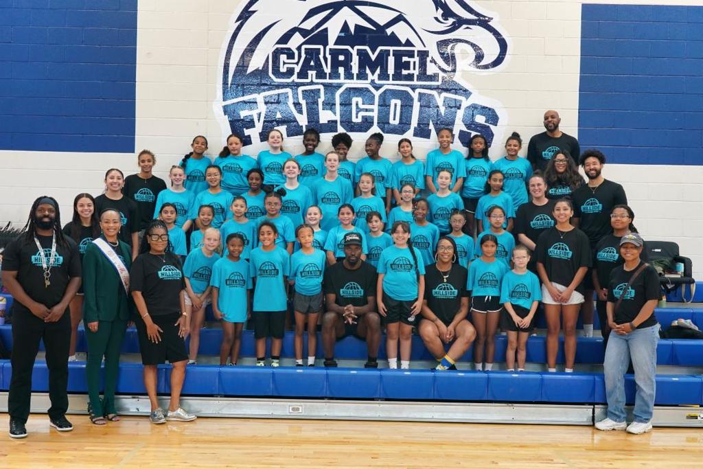 students smile in group inside gym