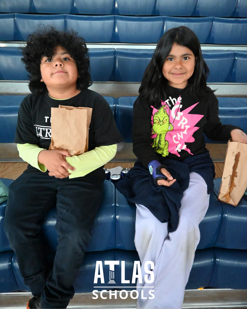 Kids smile with bags of popcorn