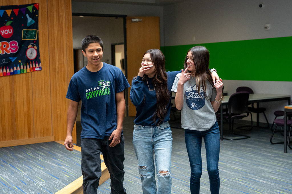 three students laugh