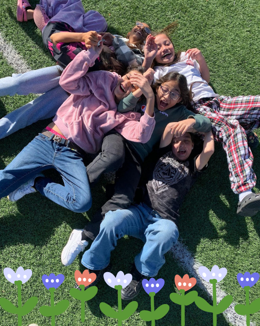 students play on playground with flower icons