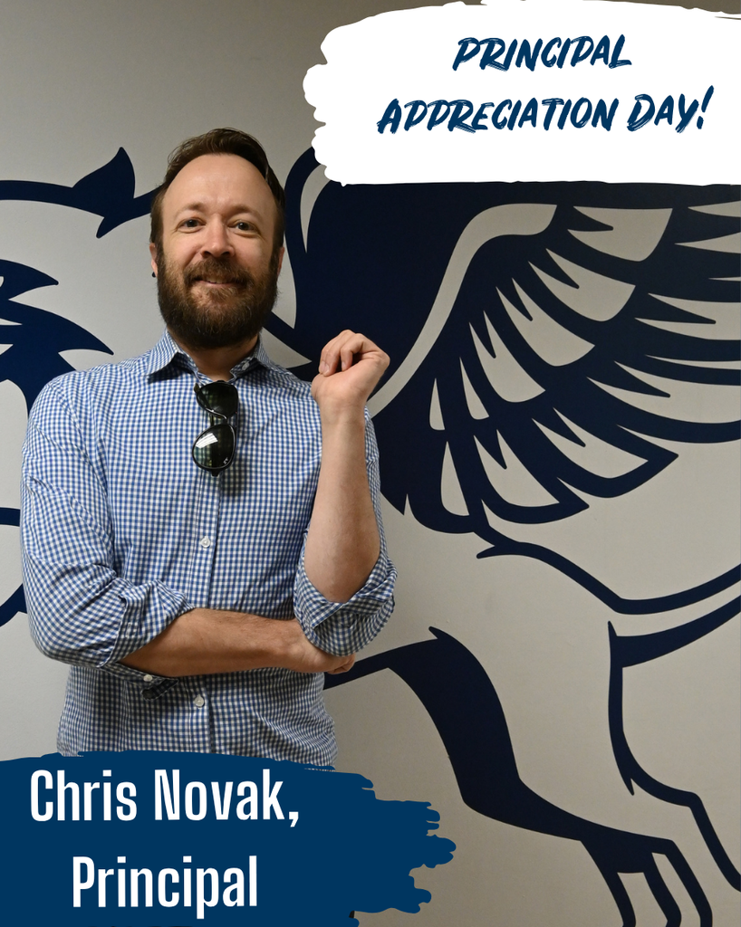 Principal smiles with gryphon behind him
