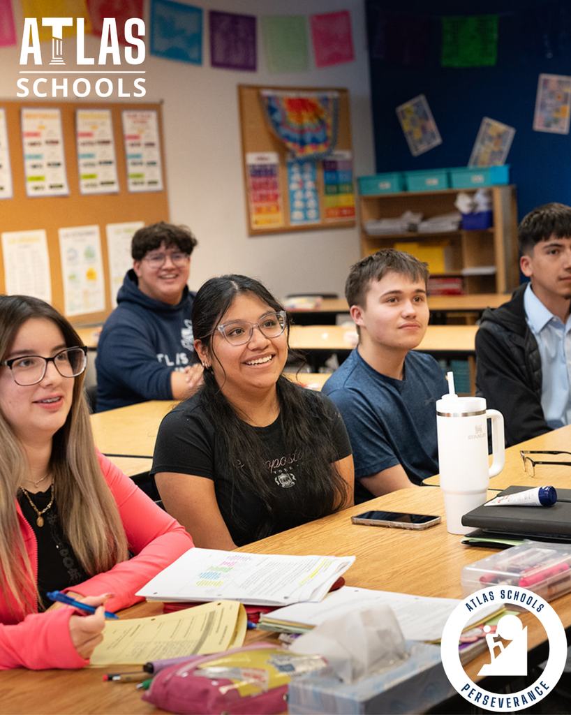 students smile at a desk