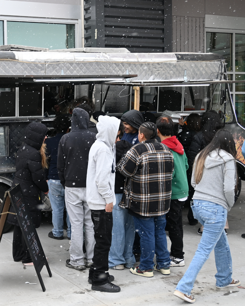 students stand at food truck