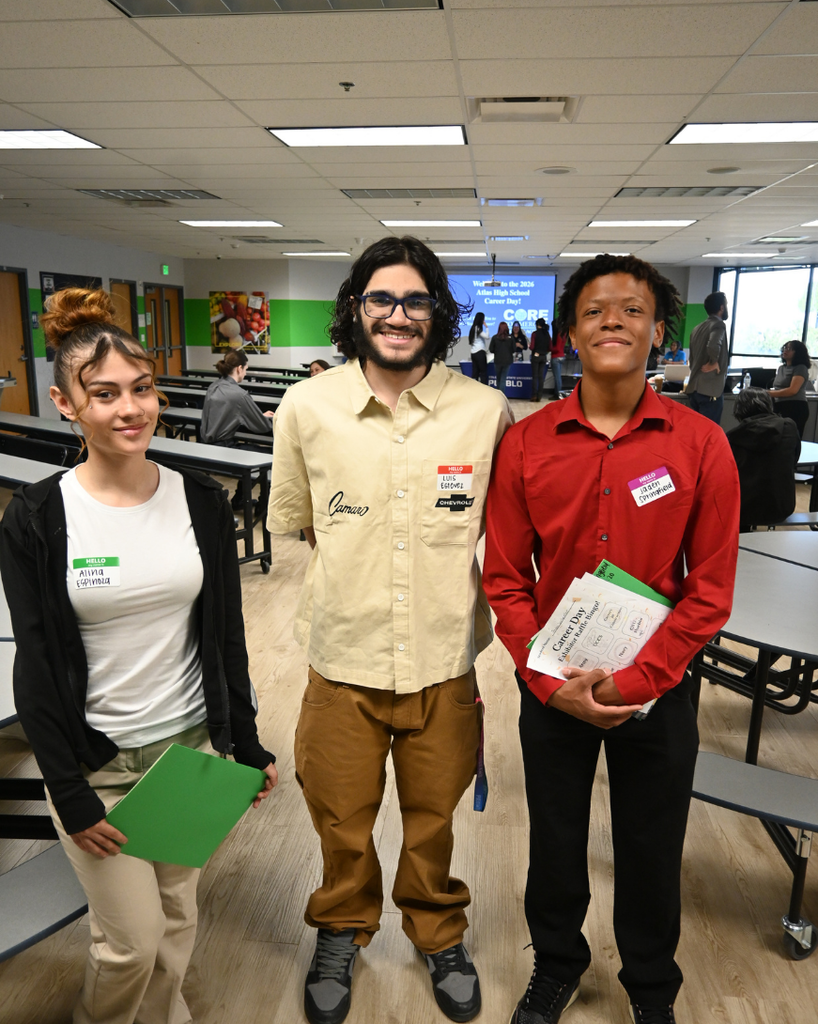 three students smile
