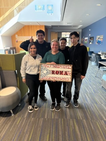 students smile with mosaics and teachers
