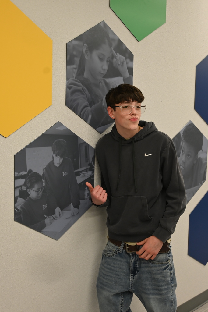 student points to himself on the wall