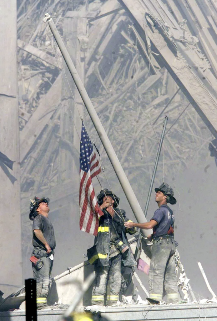 Three New York City firefighters raise an American Flag amid the rubble of the World Trade Center following the Sept. 11, 2001 terrorist attacks in New York. 