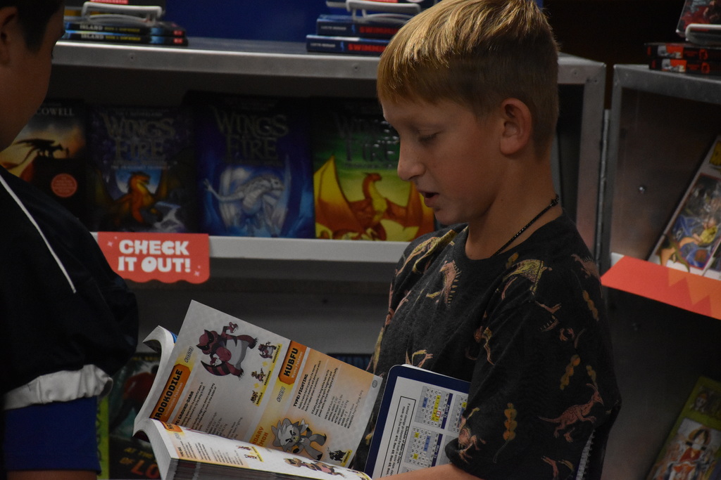 Attica Middle School students are pictured exploring the Scholastic Book Fair last week. 