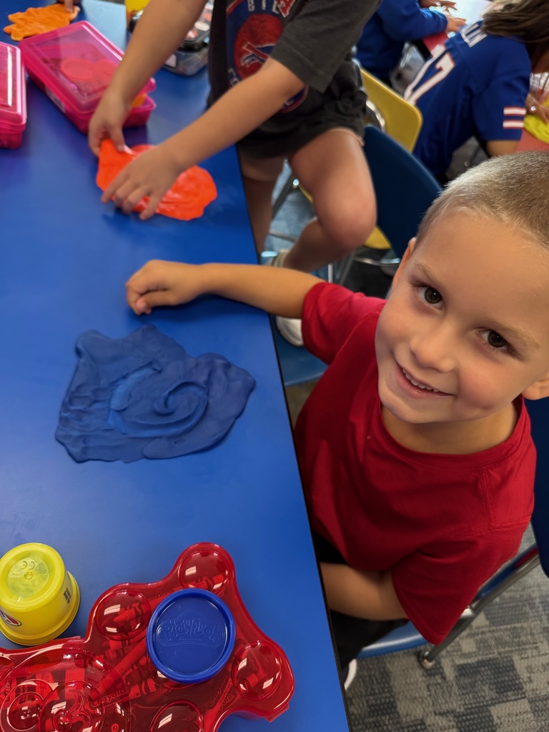 Mrs. Audra Landis’s kindergarten students are pictured practicing how to use common school supplies such as like playdoh, scissors, glue, dice, markers, pencils and crayons.