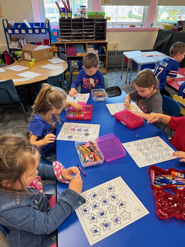 Mrs. Audra Landis’s kindergarten students are pictured practicing how to use common school supplies such as like playdoh, scissors, glue, dice, markers, pencils and crayons.