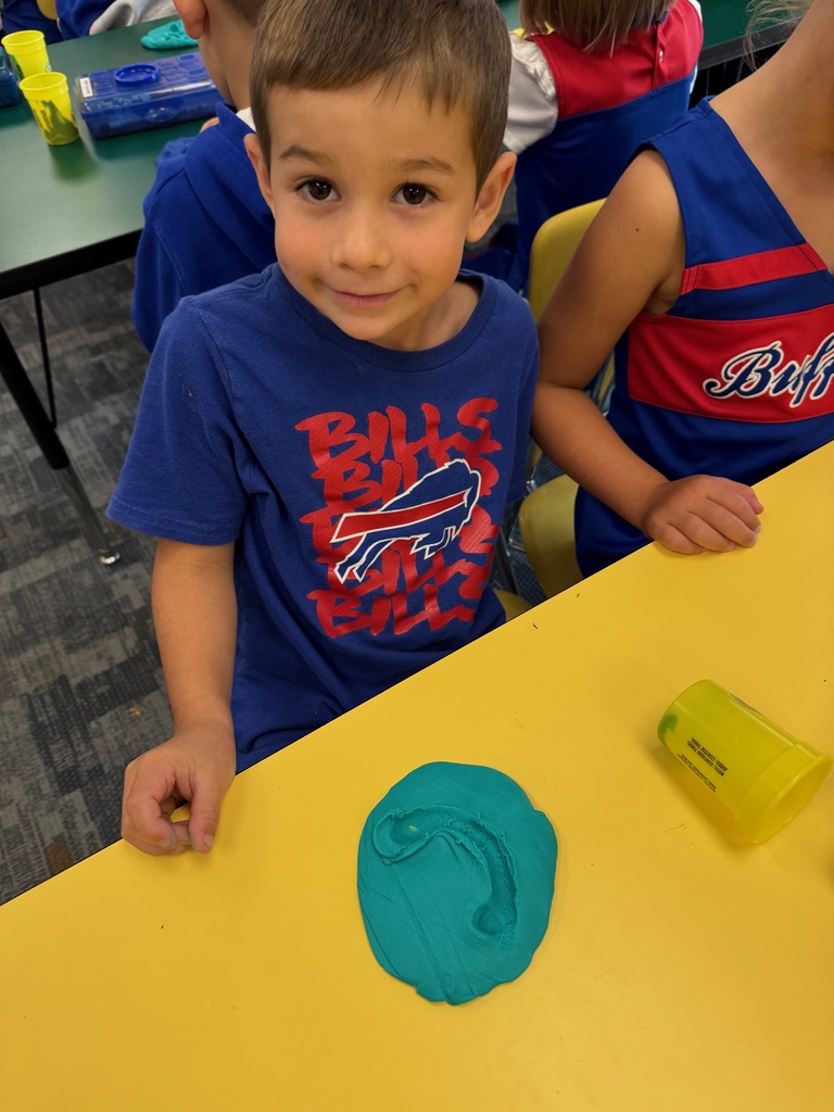 Mrs. Audra Landis’s kindergarten students are pictured practicing how to use common school supplies such as like playdoh, scissors, glue, dice, markers, pencils and crayons.
