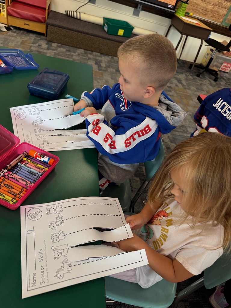 Mrs. Audra Landis’s kindergarten students are pictured practicing how to use common school supplies such as like playdoh, scissors, glue, dice, markers, pencils and crayons.