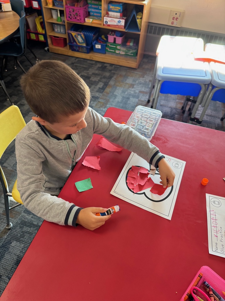 Mrs. Audra Landis’s kindergarten students are pictured practicing how to use common school supplies such as like playdoh, scissors, glue, dice, markers, pencils and crayons.