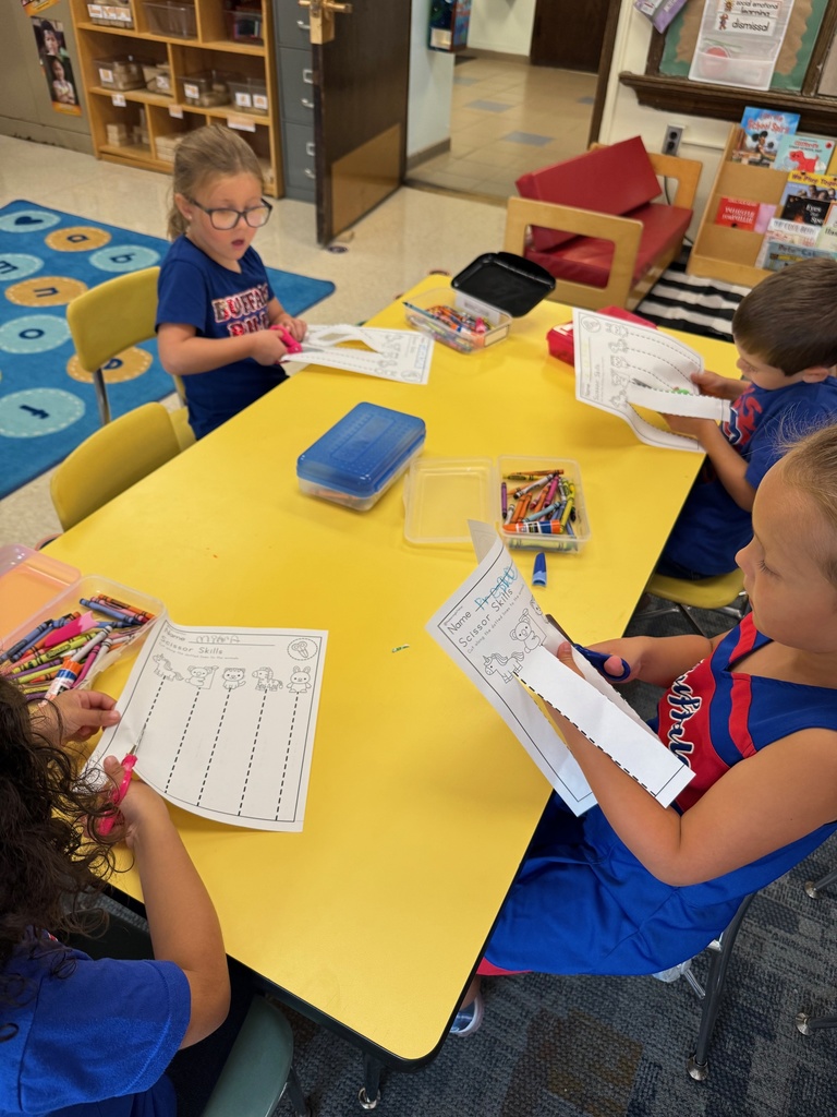 Mrs. Audra Landis’s kindergarten students are pictured practicing how to use common school supplies such as like playdoh, scissors, glue, dice, markers, pencils and crayons.