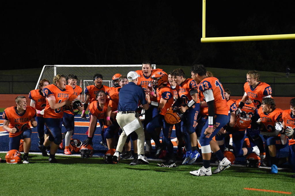 Attica's varsity football team celebrates after its Homecoming win over Geneseo/Mount Morris Friday night.