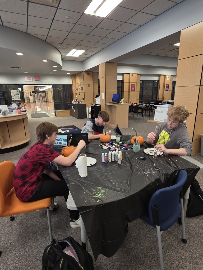 Scenes from pumpkin painting in the High School Library Friday. 
