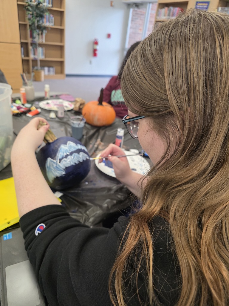 Scenes from pumpkin painting in the High School Library Friday. 