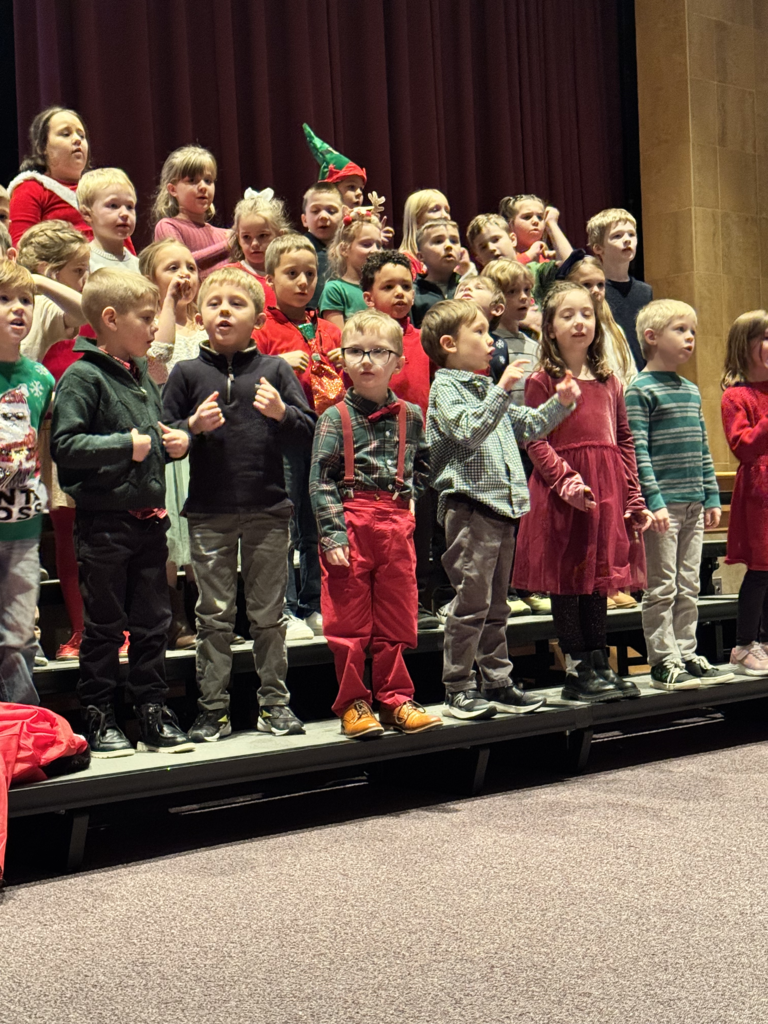 First graders are pictured performing at their holiday concert earlier this week.