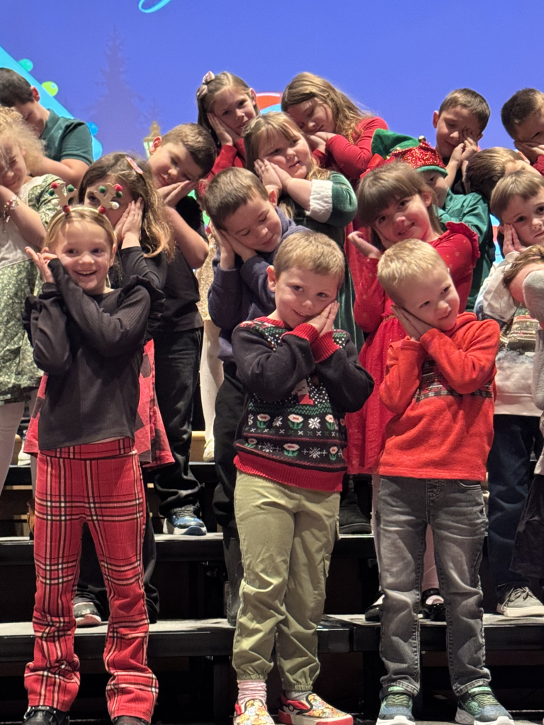 First graders are pictured performing at their holiday concert earlier this week.