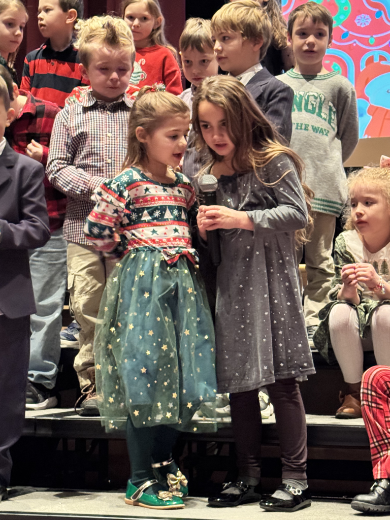 First graders are pictured performing at their holiday concert earlier this week.