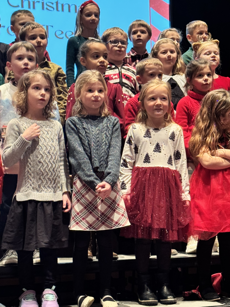 First graders are pictured performing at their holiday concert earlier this week.