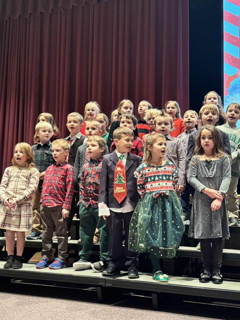 First graders are pictured performing at their holiday concert earlier this week.