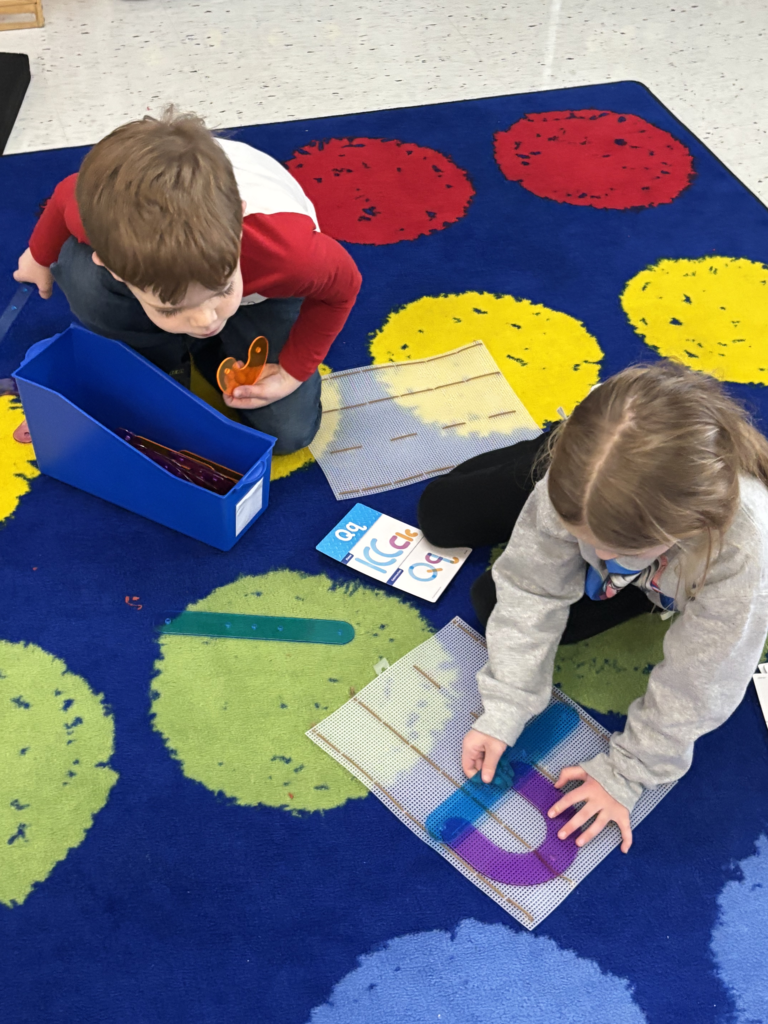 Scenes from kindergarteners’ letter games activities earlier this week. 