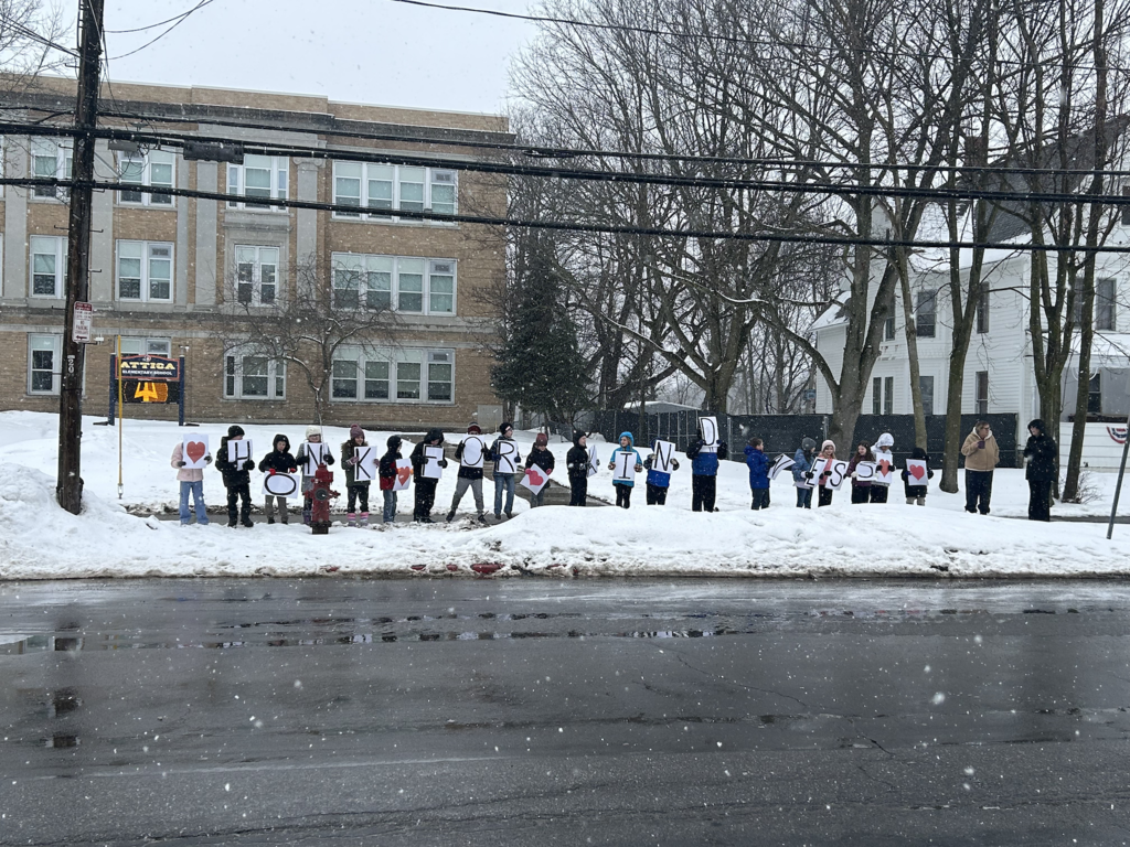 First and third graders participate in their annual ‘Honk for Kindness’ rally in front of Attica Elementary School Wednesday.