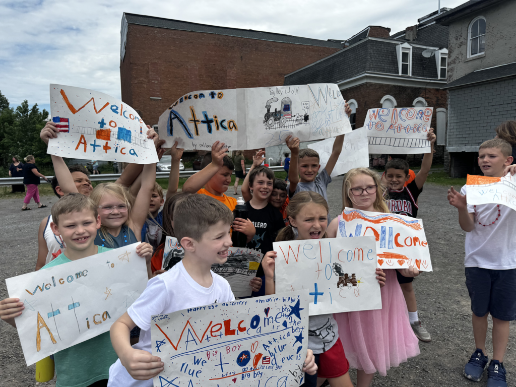 Attica Elementary School students welcome the Union Pacific ‘Big Boy’ 4014 steam locomotive on its swing through Attica Thursday morning.