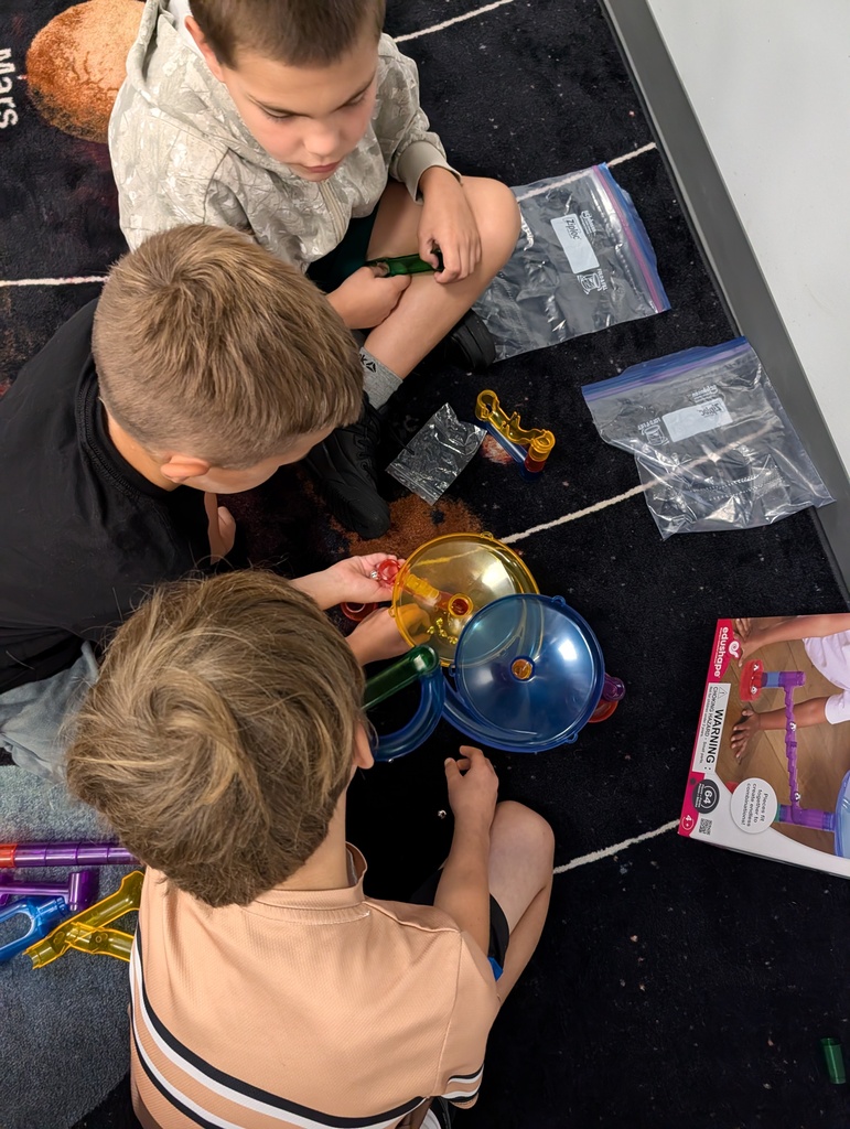 Students problem solving a marble run experiment.