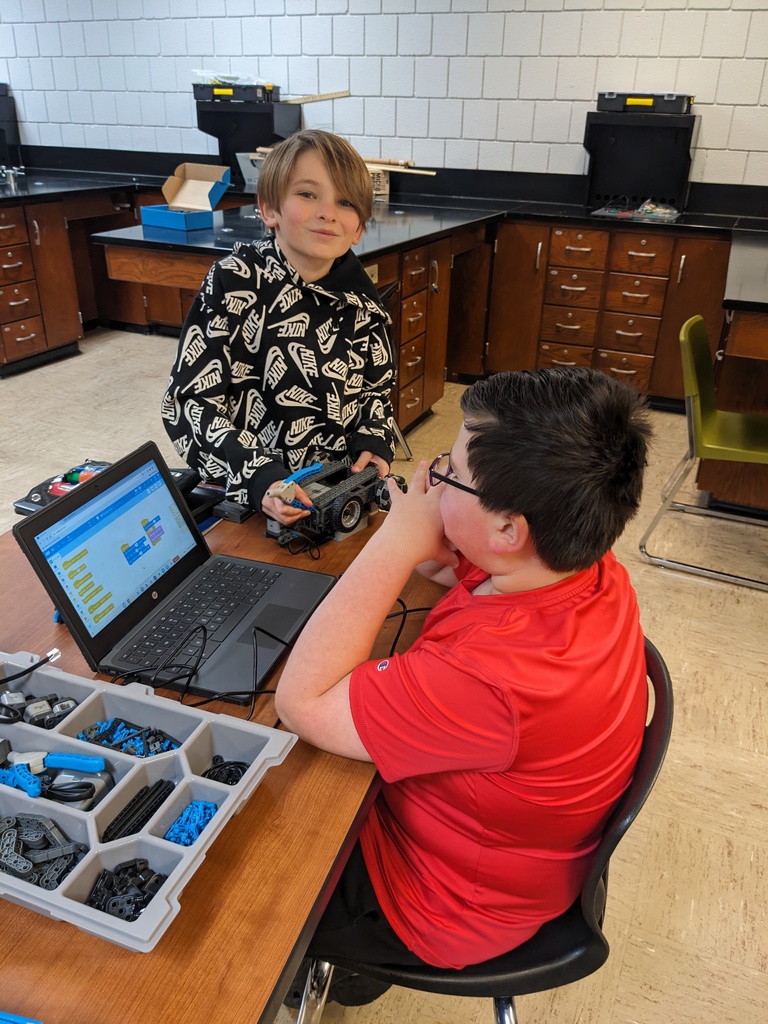 High Ability Students developing code their robot to run.