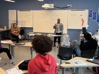 Ms. V Leading a discussion regarding mental health with Junior High Students