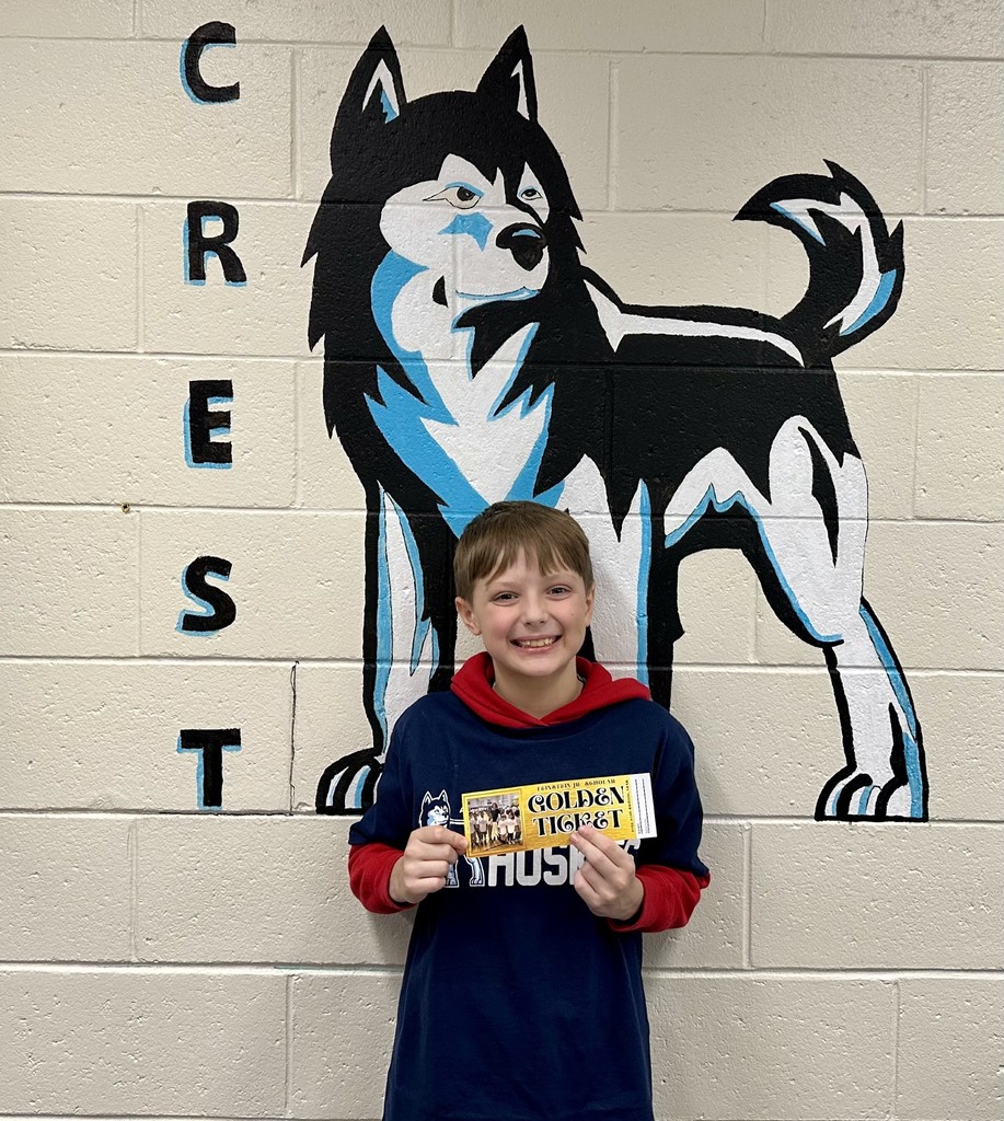 student holding golden ticket