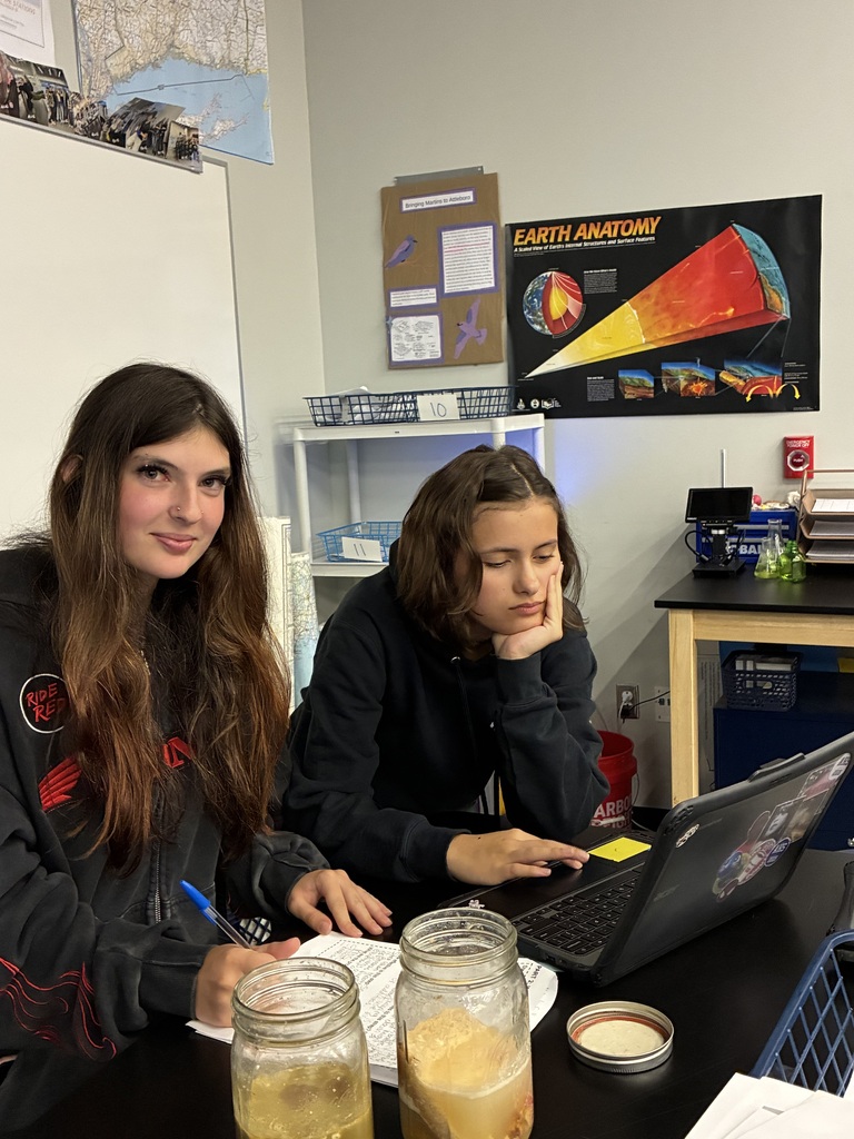 Environmental Science students Brooke Sullivan (left) and Isabella Smith are learning about wastewater treatment.  Wednesday's lunch has begun to break down in the jar on the left.