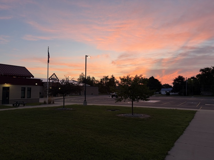 pink sky at dawn with school in the foreground