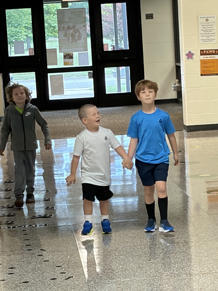 two young students holding hands on the way to breakfast