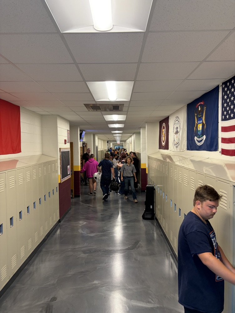 middle school students at lockers and in hallway