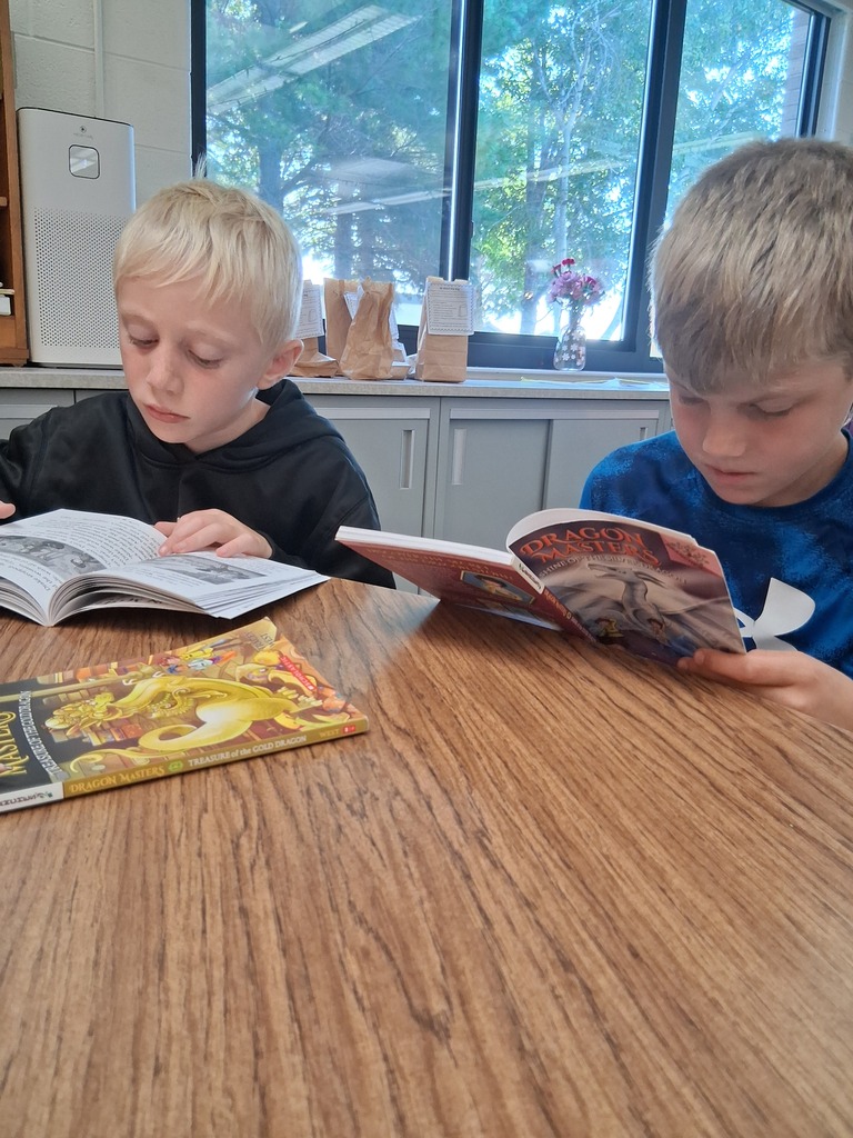 Students reading at a table.
