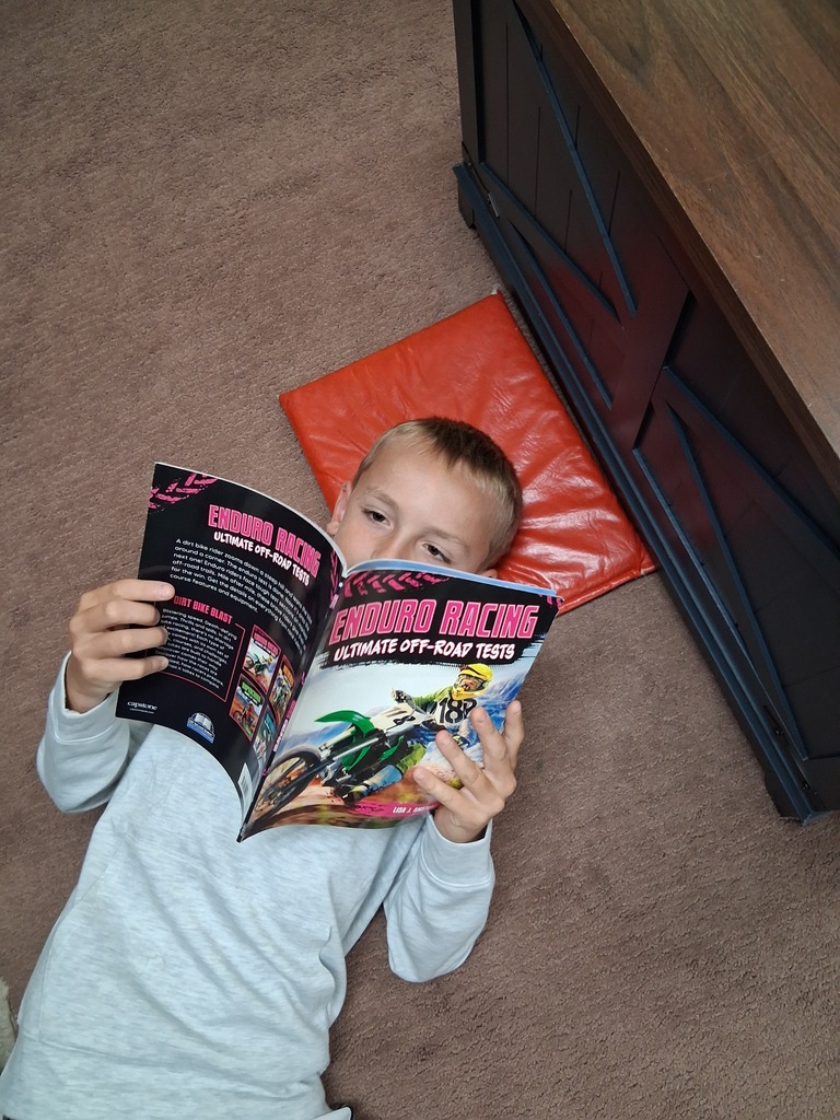 Student reading on the classroom floor.