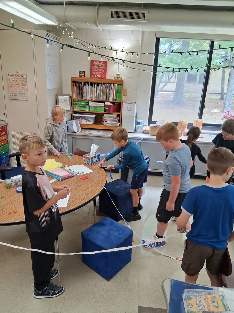 Students working to build the biggest bridge for Fred the worm to cross.