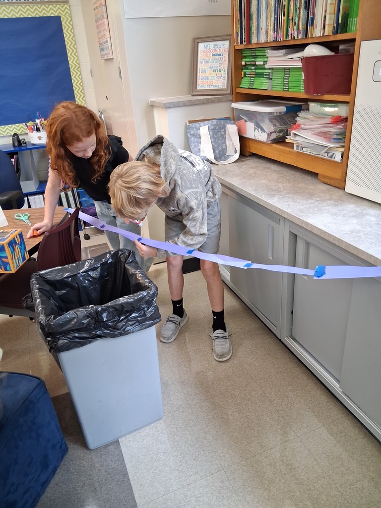 Students working to build the biggest bridge for Fred the worm to cross.