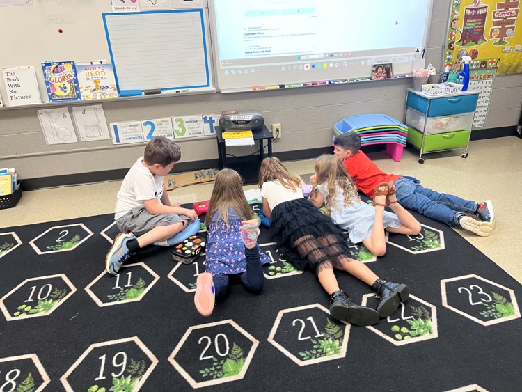 5 students listening to an audio story 