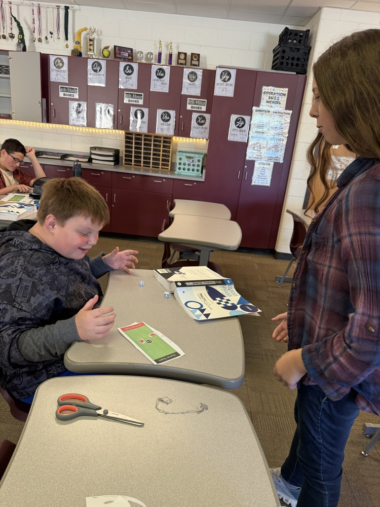 two students rolling dice and playing integer football