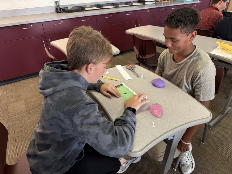 two students rolling dice and playing integer football