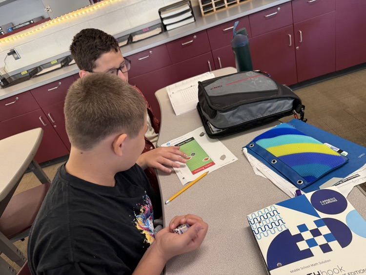 two students rolling dice and playing integer football