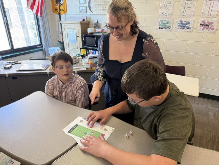 two students rolling dice and playing integer football